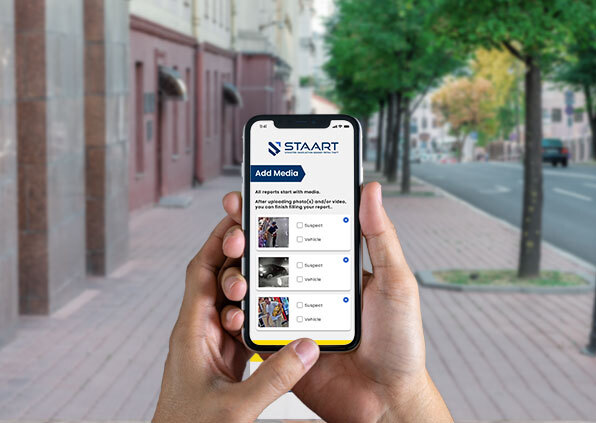 A hand holding a mobile phone with the FastSTAART app on the screen.